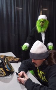 Grayson Waller Causes Christmas Chaos in Grinch Costume Backstage