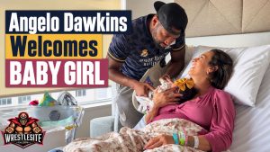 Angelo Dawkins holds his newborn daughter in the hospital after welcoming his third child with Grace Russo